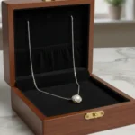 Silver plated necklace with freshwater pearl pendant in minimalist floral setting on chain