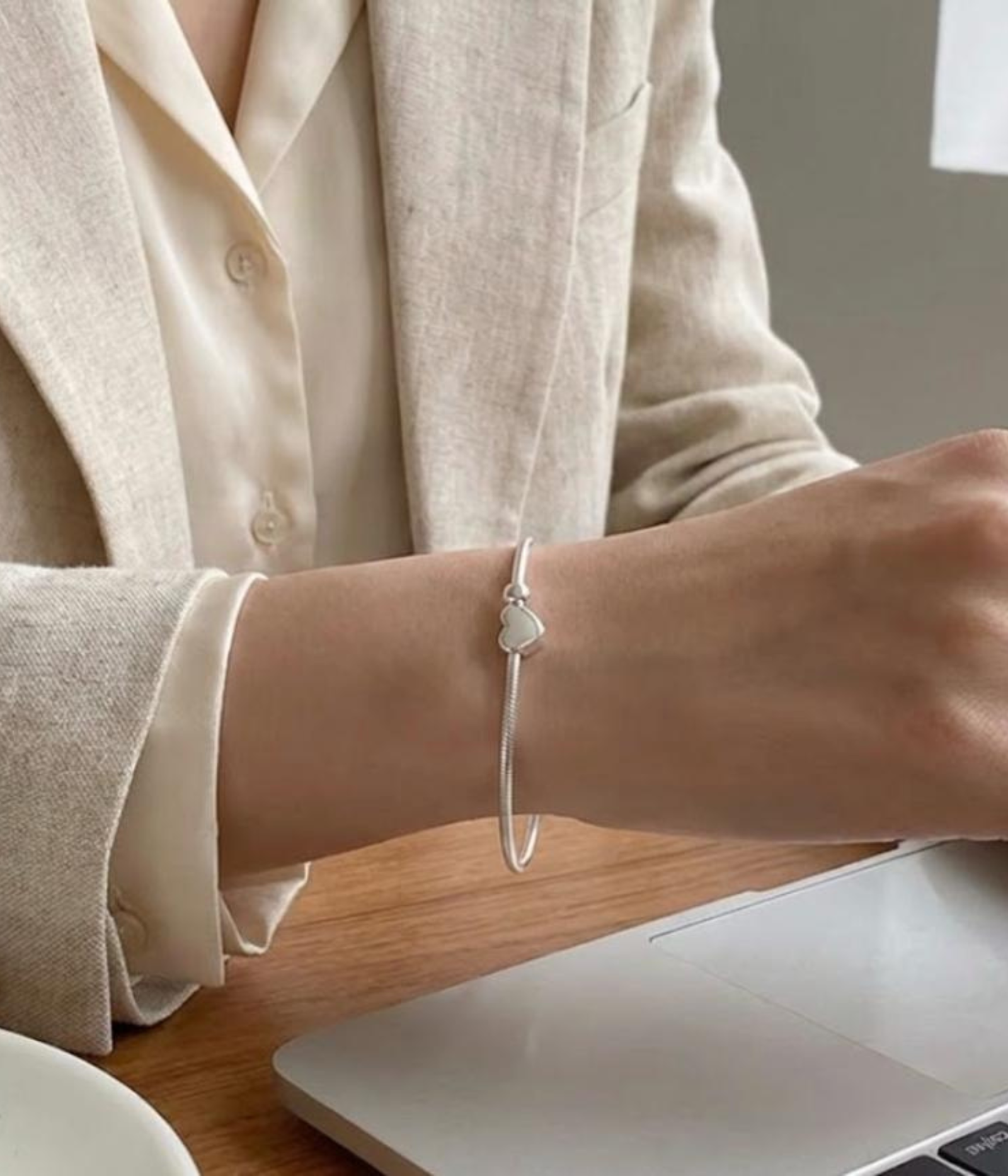 Silver plated snake chain bracelet with polished heart charm and adjustable clasp