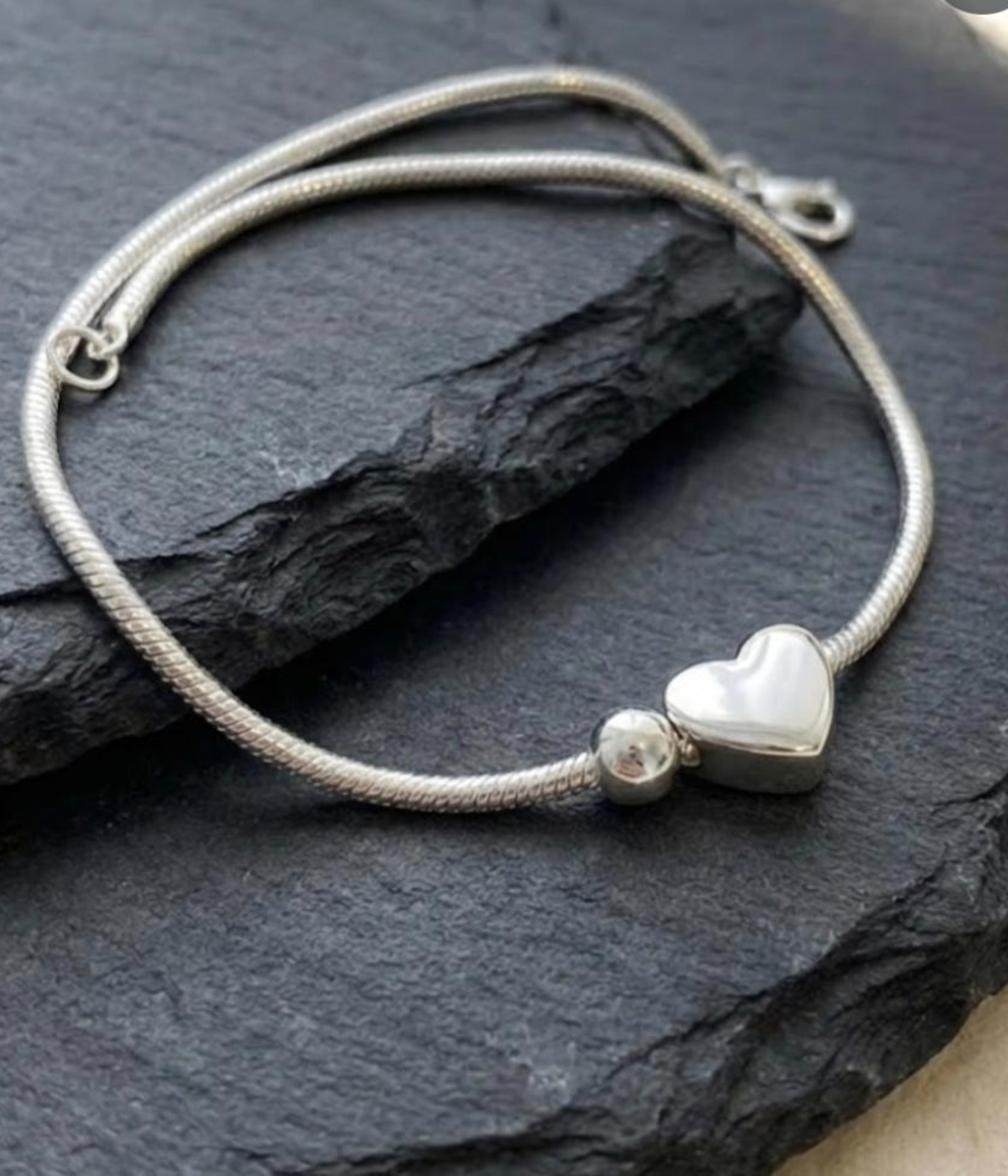 Silver plated snake chain bracelet with polished heart charm and adjustable clasp