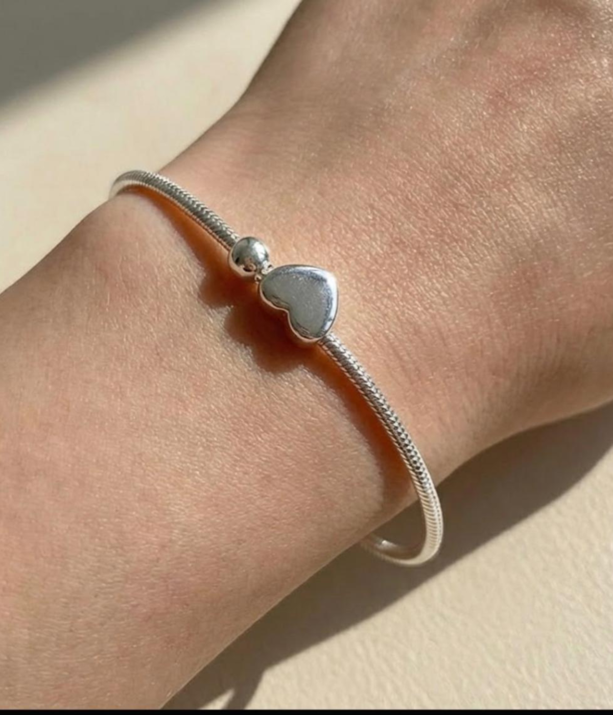 Silver plated snake chain bracelet with polished heart charm and adjustable clasp