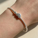 Silver plated snake chain bracelet with polished heart charm and adjustable clasp