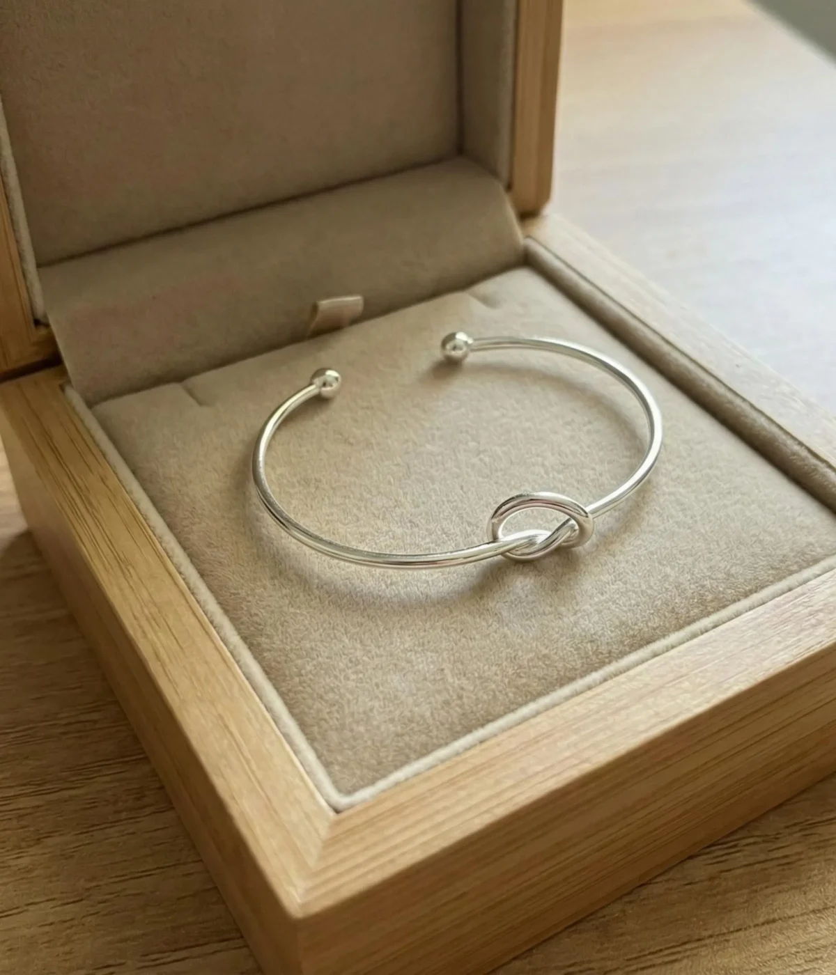 Gemini said A minimalist silver plated heart charm bracelet on a sleek snake chain with an adjustable clasp, displayed on a clean background.