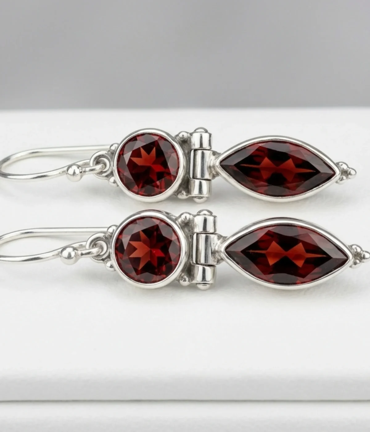 925 sterling silver drop earrings with deep red garnet stones in round and marquise cuts, elegant dangle design for women.