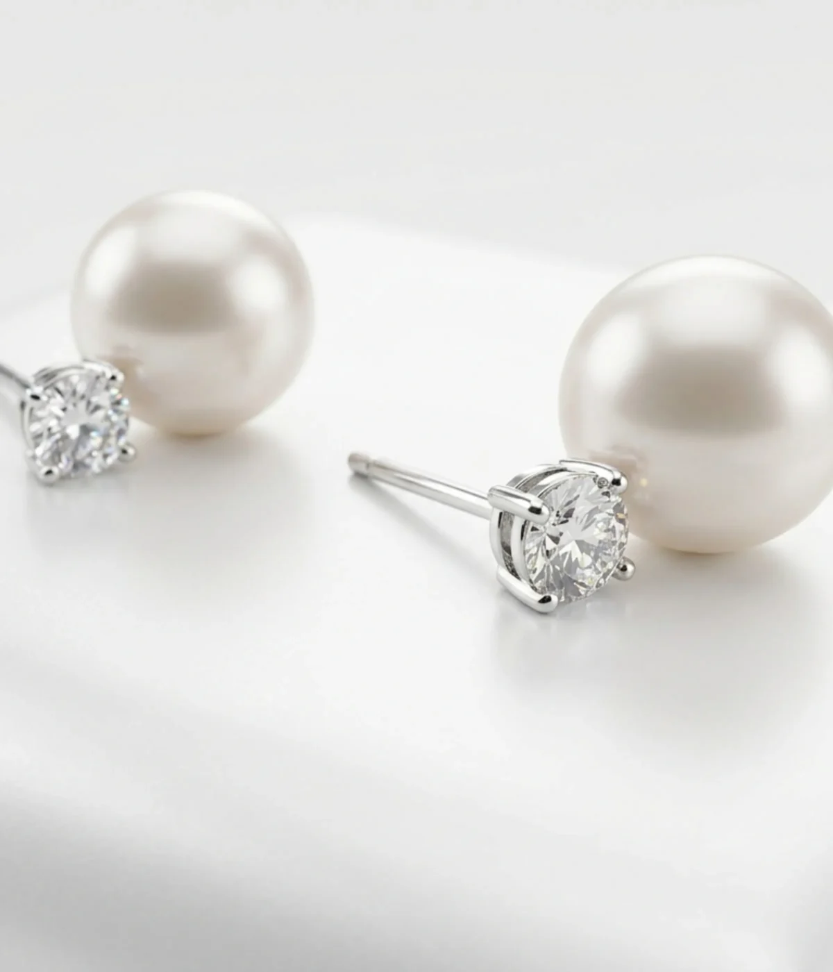 925 sterling silver stud earrings featuring white freshwater pearl and round cubic zirconia, elegant dual-stone design, 5.5 gm.