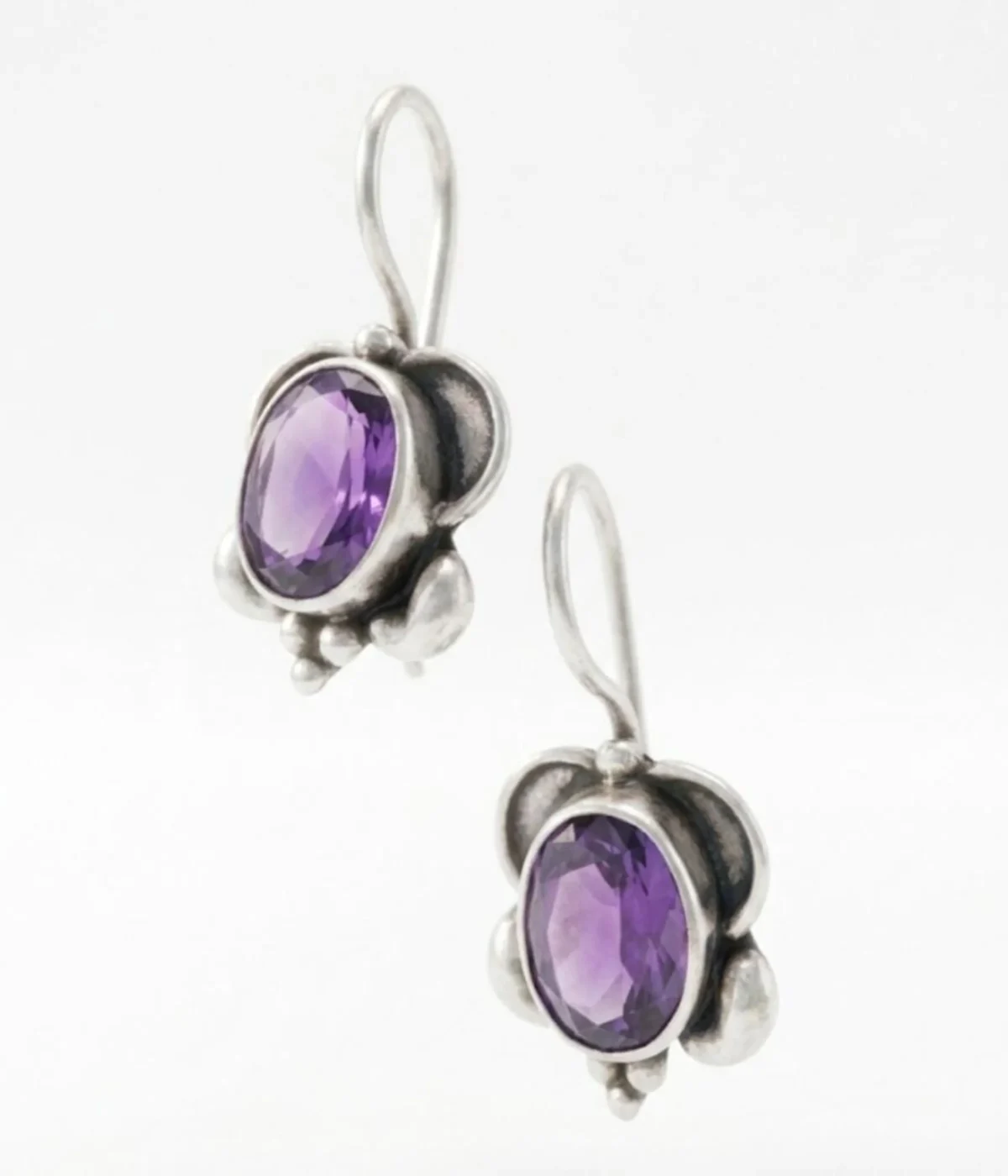 925 sterling silver drop earrings with oval purple amethyst gemstone in vintage-style bezel setting with hook closure.