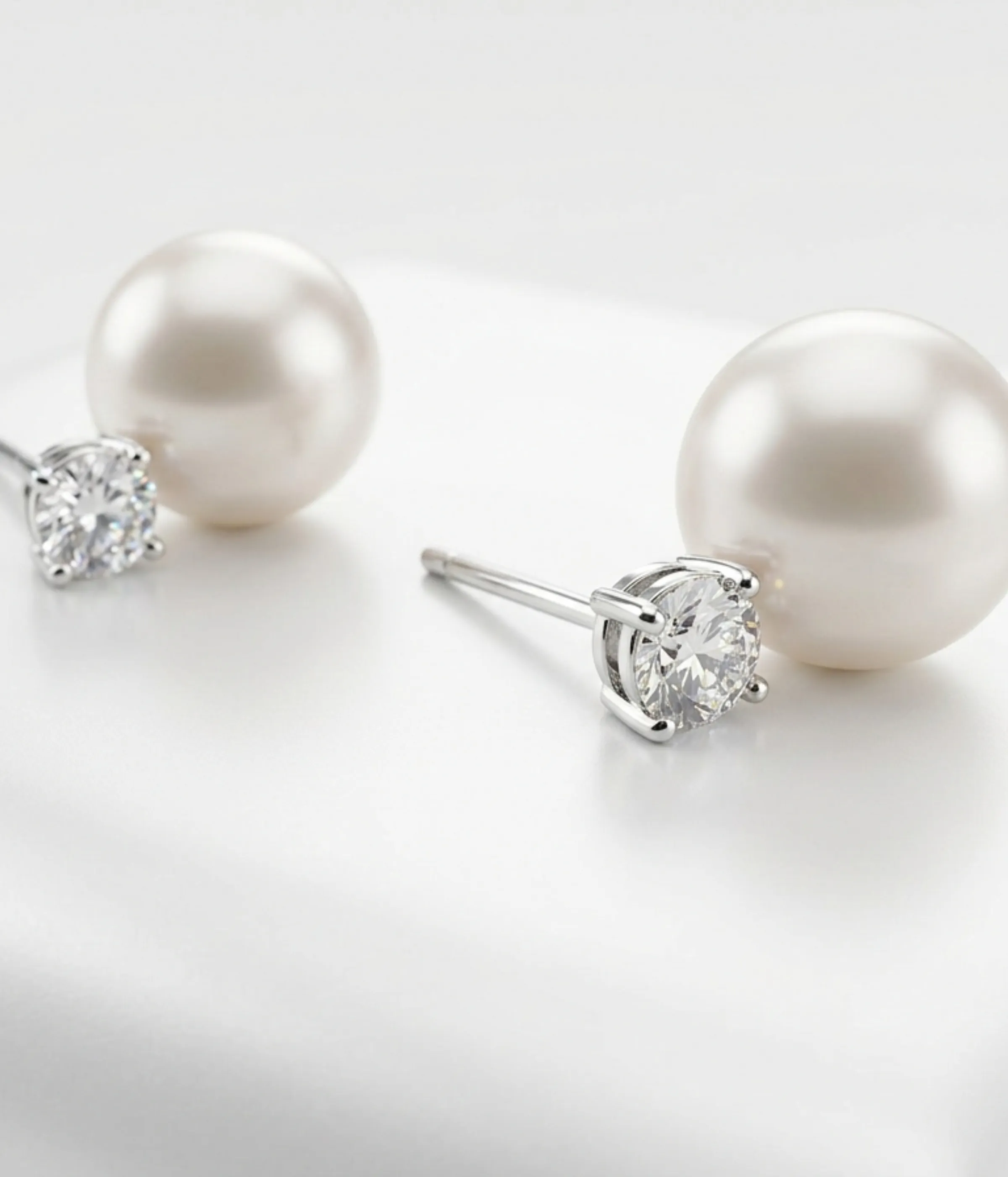 925 sterling silver stud earrings featuring white freshwater pearl and round cubic zirconia, elegant dual-stone design, 5.5 gm.