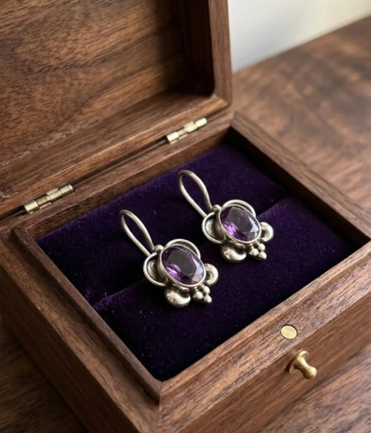 925 sterling silver drop earrings with oval purple amethyst gemstone in vintage-style bezel setting with hook closure.
